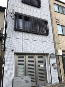 a building with two doors and two windows on it at 寧寧の道（Nenenomichi） in Kyoto