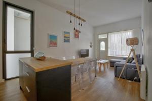 a kitchen and living room with a table and chairs at Boulevard de la Plage flat in Arcachon