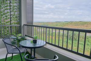 a table and chairs on a balcony with a view at Zimbali Lakes Boulevard Suites in Ballito