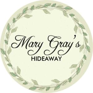 a wreath of green leaves in a happy may cry hiberry sign at Mary Grays Hideaway 2 Bedroom Irish Cottage 