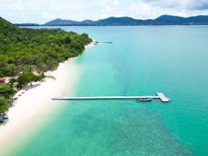 an aerial view of a beach with a boat in the water at Cruiser Island By Swiss-Belhotel in Ko Lone