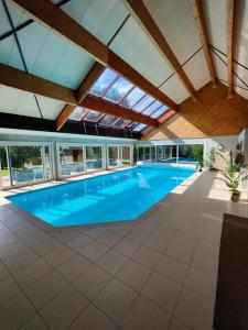 an indoor swimming pool with a skylight and a ceiling at Villa Margaux in Lampertheim