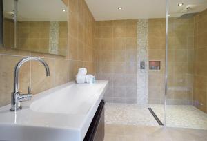 a bathroom with a sink and a shower at Brook Lodge Essex in Chappel