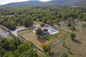 an aerial view of a house in the middle of a forest at Holiday Home Domina in Sinj