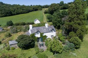 an aerial view of a white house in a field at Bryn Rhydd in Eglwys-Fâch