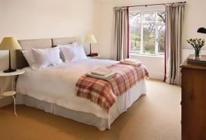 a bedroom with a large bed with two towels on it at Upper Mowley in Kington