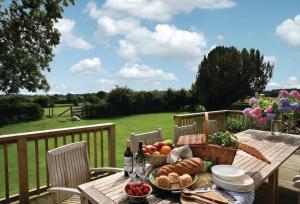 a picnic table with a basket of food on a deck at Upper Mowley in Kington
