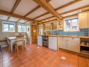 a kitchen with a table and a dining room at Bearwood House in Pembridge