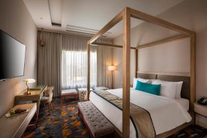 Postel nebo postele na pokoji v ubytování Sarovar Premiere Jaipur