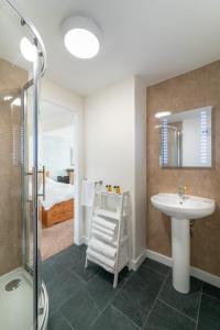 a bathroom with a sink and a shower at Harbour Guest House in Tobermory