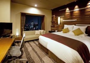 a hotel room with a bed and a desk and a television at Hotel Granvia Osaka-JR Hotel Group in Osaka +37 photos