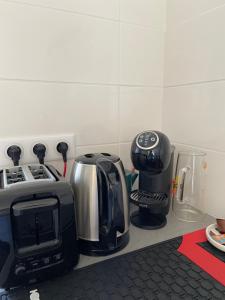 a kitchen counter with a coffee maker and a toaster at A deux pas de la grande plage in Quiberon