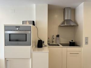 a small kitchen with a refrigerator and a sink at studio Monserrate F in Torrevieja