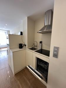 a small kitchen with a sink and a refrigerator at studio Monserrate F in Torrevieja