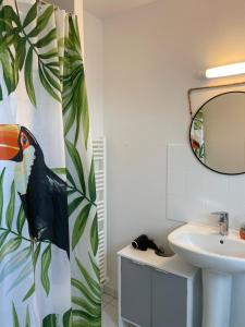 a bathroom with a sink and a toilet and a mirror at A deux pas de la grande plage in Quiberon +7 photos