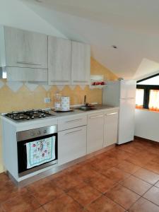 eine Küche mit einem Herd und einem Kühlschrank in der Unterkunft La casa di Antonella in Vico del Gargano