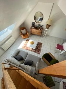 a living room with a couch and a mirror at A deux pas de la grande plage in Quiberon
