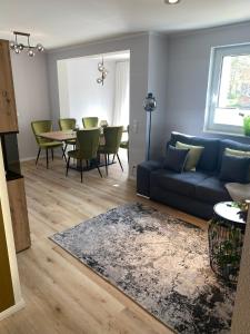 uma sala de estar com um sofá azul e uma mesa em Spree Chalet Cottbus em Cottbus