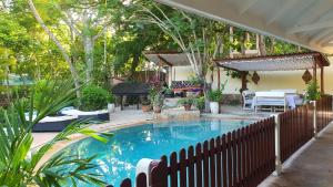 a swimming pool in a yard with a fence at Mami Wata House in Kwale