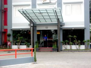 a man standing in the entrance of a building at Wirton Hotel in Bandung