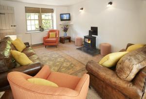 a living room with two couches and a fireplace at Courtyard House in Kelso