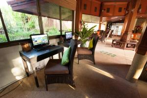 a room with a desk with two laptops on it at Pinnacle Samui Resort in Mae Nam