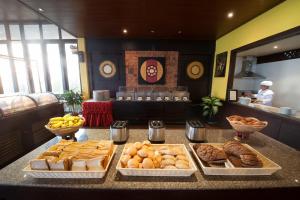 a table with several trays of different types of bread at Pinnacle Samui Resort in Mae Nam