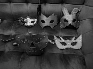 un groupe de masques suspendus sur un mur dans l'établissement Fifty Shapes, à Nesher