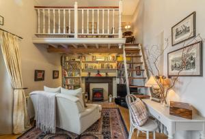 a living room with a staircase and a fireplace at Pillar Box House in Kimberley