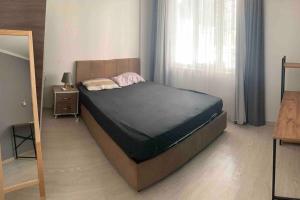 a bedroom with a bed and a window at Lux apartment in Cafeler caddesi in Antalya