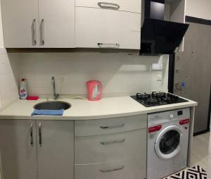 a kitchen with a sink and a washing machine at Lux apartment in Cafeler caddesi in Antalya