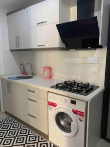 a kitchen with a stove and a washing machine at Lux apartment in Cafeler caddesi in Antalya