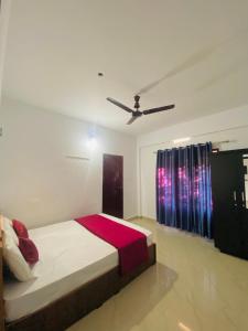 a bedroom with a bed and a ceiling fan at Green Line Homestay in Vythiri