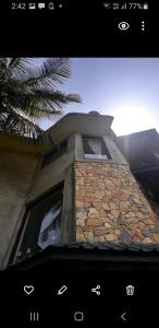 a building with a stone wall and a window at Mount Haven in Kandy