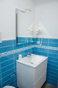 a bathroom with a white sink and a mirror at La Rosa Dei Venti in Acciaroli