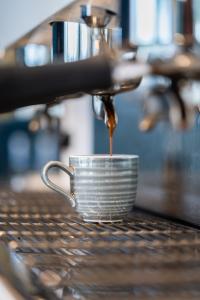 a coffee maker is making a cup of coffee at BMC Home in Boscotrecase