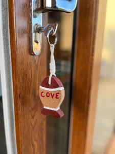 a tag on a door with the word love on it at Cove Shepherds Hut in Penally