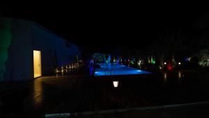 a night view of a courtyard with a building at The Palm Estate in Fujairah