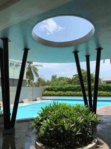 a house with a swimming pool and a circular ceiling at CASA ELIRA Aesthetic 2 BR Condo Unit Iloilo in Iloilo City