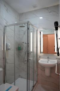 a bathroom with a shower and a sink at The Maltese Sun in Sliema