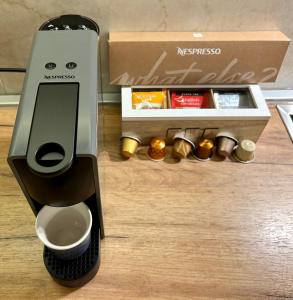 aissos coffee machine sitting next to a box at Apartment SUN CITY 1 in Belgrade