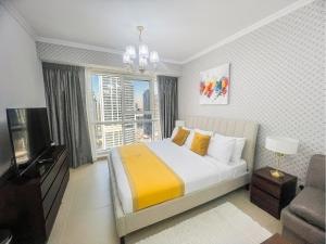 a bedroom with a bed and a large window at Cosmos Living Modern Studio Near Dubai Marina in Dubai