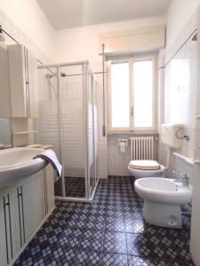 a bathroom with a toilet and a sink and a shower at Miramare Apartments in Otranto