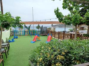 a playground with colorful slides and tables and chairs at Chrysoula's Paradise in Istro