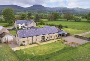 an aerial view of a house with a large yard at The Longbarn at Caerfallen in Ruthin