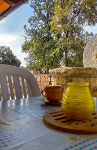 a table with two yellow vases on top of it at Apartments MULOBEDANJ in Lun +22 photos