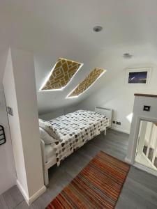 a bedroom with a bed in a room at Magnolia Passageway to the Jurassic Coast. in Stoborough