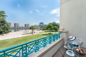 a balcony with a table and a view of a river at Al Raha Beach Resort & Spa in Abu Dhabi