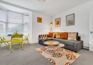a living room with a couch and a table at Station Walk By My Getaways in Brighton & Hove