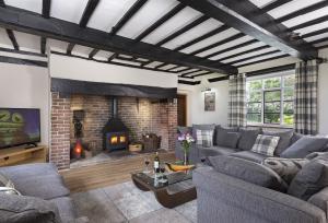 a living room with a couch and a fireplace at Broad Meadows Farmhouse 8 Guests in Bayton